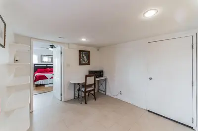 a living room with a table and a bedroom at Paradise On Earth residence in Lake Elsinore
