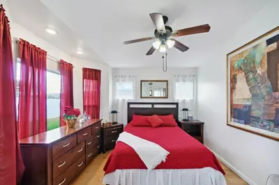 a bedroom with a bed and a ceiling fan at Paradise On Earth residence in Lake Elsinore