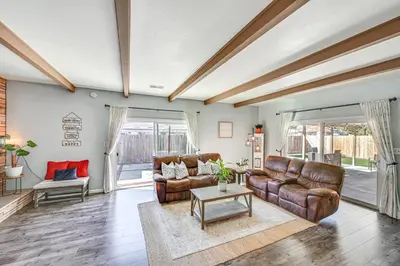 a living room with leather couches and a table at Walkable Chula Vista Home with Covered Patio in Chula Vista