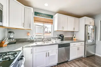 a kitchen with white cabinets and stainless steel appliances at Walkable Chula Vista Home with Covered Patio in Chula Vista