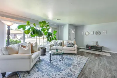 a living room with two couches and a table at Walkable Chula Vista Home with Covered Patio in Chula Vista
