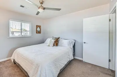 a bedroom with a bed and a ceiling fan at Walkable Chula Vista Home with Covered Patio in Chula Vista