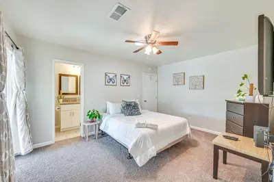 a bedroom with a bed and a ceiling fan at Walkable Chula Vista Home with Covered Patio in Chula Vista