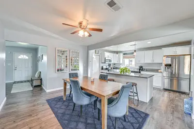 a kitchen and dining room with a wooden table and chairs at Walkable Chula Vista Home with Covered Patio in Chula Vista