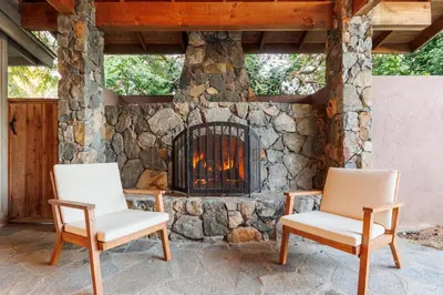 two chairs sitting in front of a stone fireplace at CBS-501 - Cardiff Hillside Hideaway in Cardiff-by-the-Sea