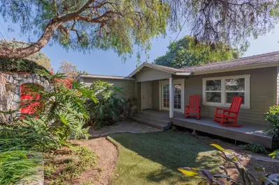 a house with two red chairs on a porch at CBS-501 - Cardiff Hillside Hideaway in Cardiff-by-the-Sea