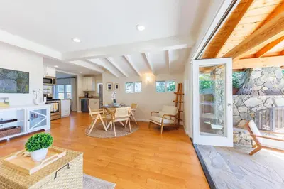 a kitchen and living room with a stone wall at CBS-501 - Cardiff Hillside Hideaway in Cardiff-by-the-Sea