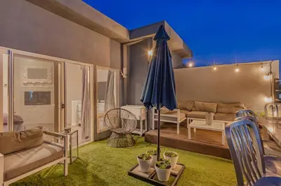 a living room with a couch and an umbrella at 4BR Spectacular Harbor View Modern Home 5min Zoo in San Diego