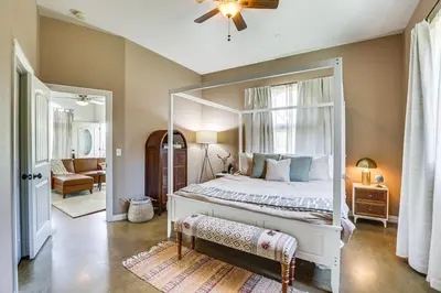 a bedroom with a canopy bed with a mirror at Cozy Alpine Cottage Near Casinos and Trails! in Alpine
