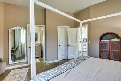 a bedroom with a bed and a mirror at Cozy Alpine Cottage Near Casinos and Trails! in Alpine