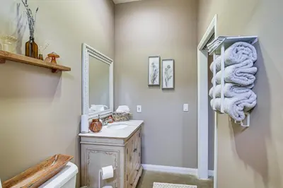a bathroom with a sink and a mirror at Cozy Alpine Cottage Near Casinos and Trails! in Alpine