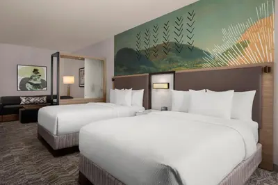a hotel room with two beds and a couch at SpringHill Suites by Marriott Chula Vista Eastlake in Chula Vista