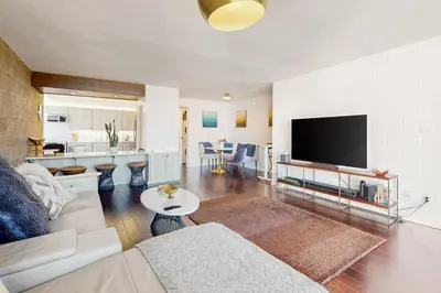 a living room with a couch and a flat screen tv at Seaside Serenity Haven -30 night min in San Diego
