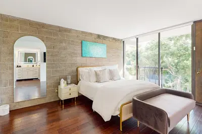 a bedroom with a large bed and a chair at Seaside Serenity Haven -30 night min in San Diego