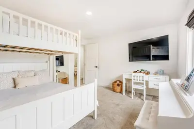 a white bedroom with a bunk bed and a desk at Amazing Views with Heated Pool and Jacuzzi Near Beach in Solana Beach