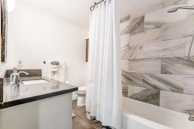 a bathroom with a tub and a sink and a shower at Amazing Views with Heated Pool and Jacuzzi Near Beach in Solana Beach