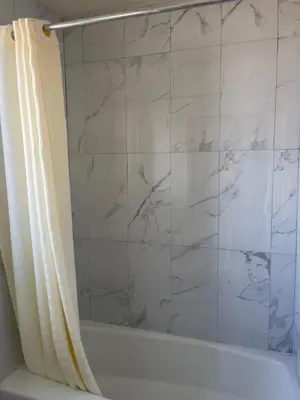 a bathroom with a shower curtain and a tub at Star Lodge Motel-Vista Oceanside in Vista