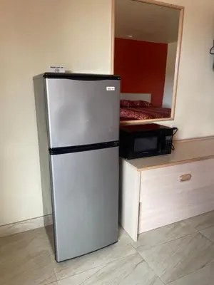 a refrigerator in a room with a microwave at Star Lodge Motel-Vista Oceanside in Vista