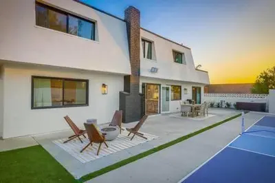a house with a patio with chairs and a table at Pickleball Paradise by Rather Be Properties in Mission Viejo
