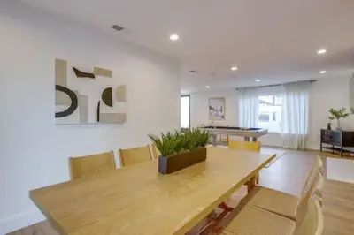 a dining room with a wooden table and chairs at Pickleball Paradise by Rather Be Properties in Mission Viejo