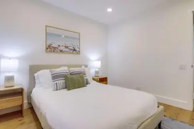 a bedroom with a large white bed with two pillows at Pickleball Paradise by Rather Be Properties in Mission Viejo