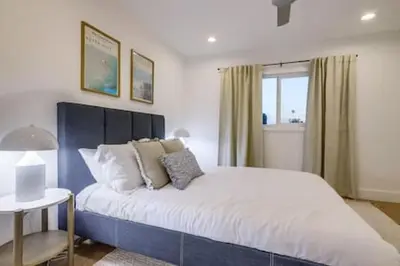 a bedroom with a blue and white bed and a window at Pickleball Paradise by Rather Be Properties in Mission Viejo