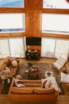 a living room with a couch and a tv at Award-Winning A-Frame with Views and Cedar Hot Tub in Julian