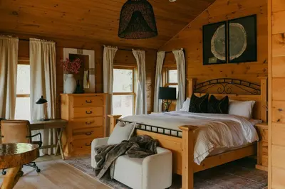 a bedroom with a bed in a wooden room at Award-Winning A-Frame with Views and Cedar Hot Tub in Julian