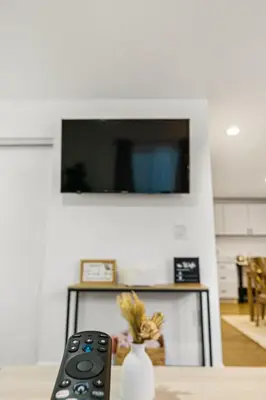 a remote control sitting on a table in front of a tv at Brand New home in San Diego 3BR Quiet neighborhood near Downtown/Seaworld/Zoo in San Diego