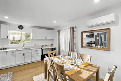 a kitchen and dining room with a table and chairs at Brand New home in San Diego 3BR Quiet neighborhood near Downtown/Seaworld/Zoo in San Diego