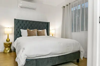 a bedroom with a large bed and a window at Brand New home in San Diego 3BR Quiet neighborhood near Downtown/Seaworld/Zoo in San Diego