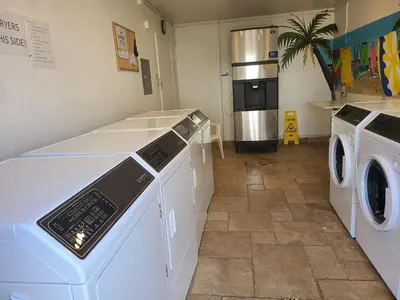 a laundry room with washing machines and a refrigerator at Amazing Location - Large and Luxurious 1 Bedroom Beach Condo By Beaches and Attractions in Solana Beach