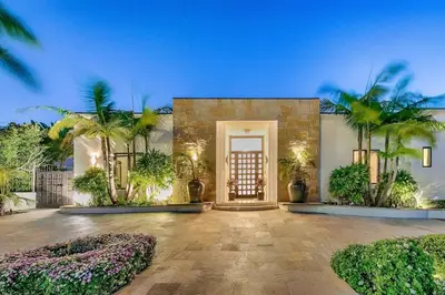 a home with palm trees in front of a door at Ocean View Serenity with Theater and Heated Pool in San Diego