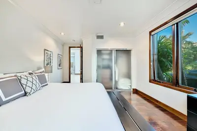 a bedroom with a large bed and a large window at Ocean View Serenity with Theater and Heated Pool in San Diego