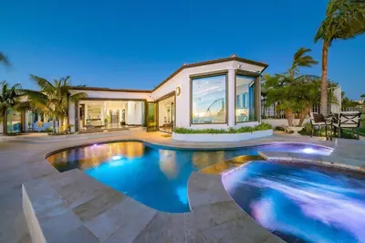 a house with a swimming pool in front of a house at Ocean View Serenity with Theater and Heated Pool in San Diego