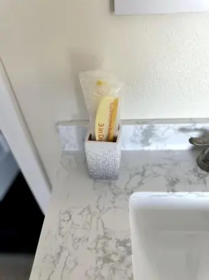 a counter top with a toothbrush and a container on it at Charming Guest House in SD in San Diego