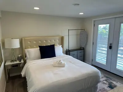 a bedroom with a large bed with a teddy bear on it at Guest House next to Little Italy in San Diego