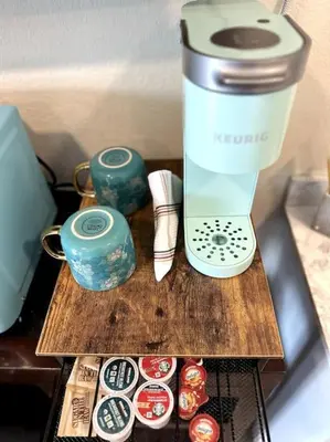 a blender sitting on a wooden table next to jars at Guest House next to Little Italy in San Diego