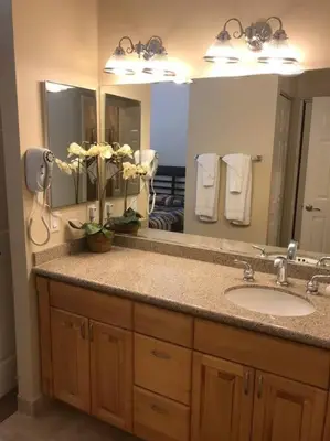 a bathroom with a sink and a large mirror at Sand Pebbles Resort - 1 Bedroom Condo in Great Location Right by the Beaches and Attractions in Solana Beach