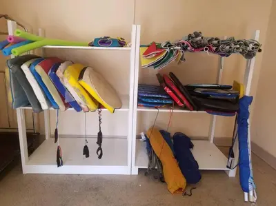 a shelf with surfboards and umbrellas in a room at Sand Pebbles Resort - 1 Bedroom Condo in Great Location Right by the Beaches and Attractions in Solana Beach