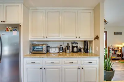 a kitchen with white cabinets and a counter with a microwave at Pet-Friendly Temecula Home in Wine Country! in Temecula