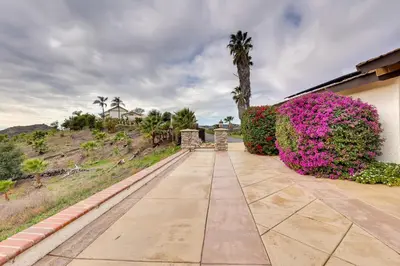 a walkway in front of a house with pink flowers at Pet-Friendly Temecula Home in Wine Country! in Temecula