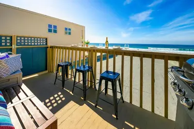 a balcony with three stools and a view of the beach at Stunning Ocean Views - Recently Renovated Home & Warm Sunsets in San Diego