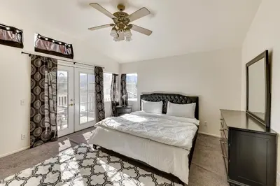 a bedroom with a bed and a ceiling fan at Lake Elsinore Home with Pool - 44 Mi to Disneyland! in Lake Elsinore