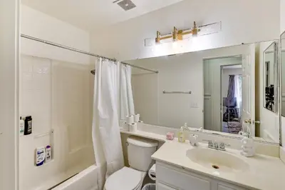 a bathroom with a toilet and a sink and a mirror at Lake Elsinore Home with Pool - 44 Mi to Disneyland! in Lake Elsinore