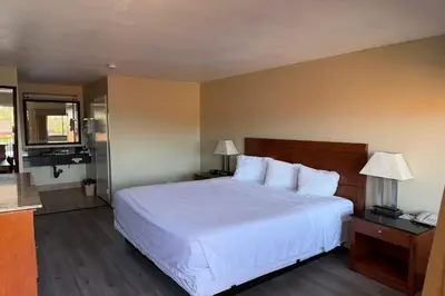 a bedroom with a white bed and two lamps at Travelodge by Wyndham Hemet CA in Hemet