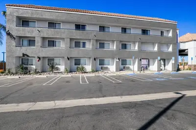 an empty parking lot in front of a building at Studio 6 Suites Perris, CA in Perris