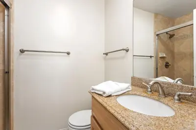 a bathroom with a sink and a toilet at 2BR Oceanfront Condo - Private Balcony - Spacious in Oceanside