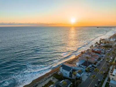 an aerial view of the beach at sunset at Romantic Getaway - Luxury Oceanfront Studio - Private Balcony - Fireplace in Oceanside