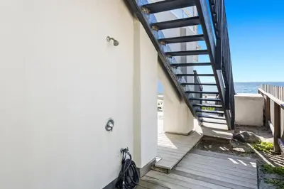 a stairway leading down to the beach from a house at Romantic Getaway - Luxury Oceanfront Studio - Private Balcony - Fireplace in Oceanside